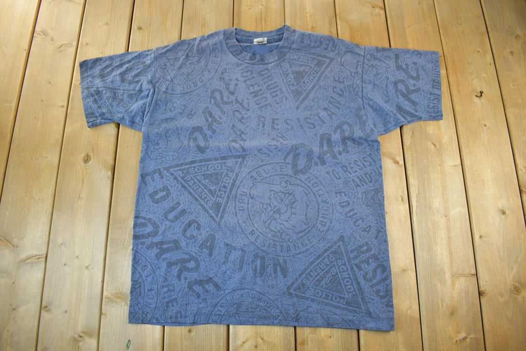 Vintage 1990s D.A.R.E All Over Print Graphic T-Shirt Men's XL