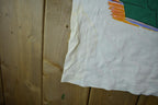 Vintage 1990s Tiny Tunes Destination Alps All Over Print Graphic T-Shirt  Warner Bros  Looney Tunes  3XL  CUT NECK