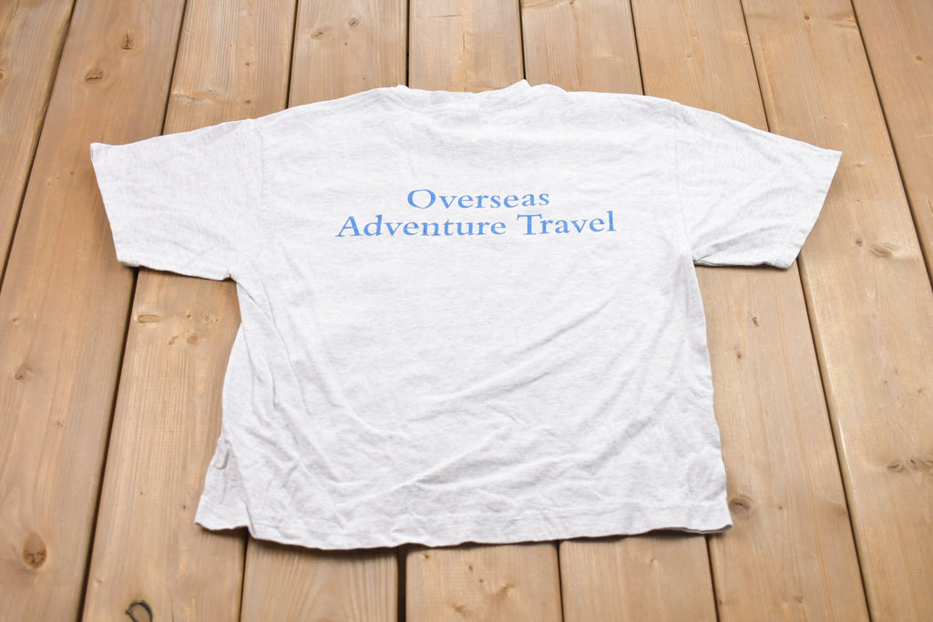 Vintage 1990s Overseas Adventure Travel Graphic T-Shirt