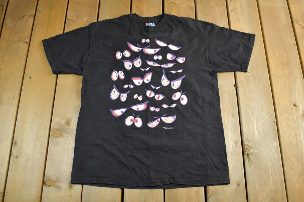 Vintage 1990s Brieland Graphics Glow In The Dark Eyes T-Shirt Men's Large