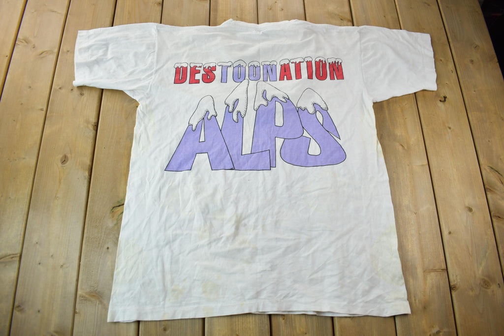 Vintage 1990s Tiny Tunes Destination Alps All Over Print Graphic T-Shirt  Warner Bros  Looney Tunes  3XL  CUT NECK