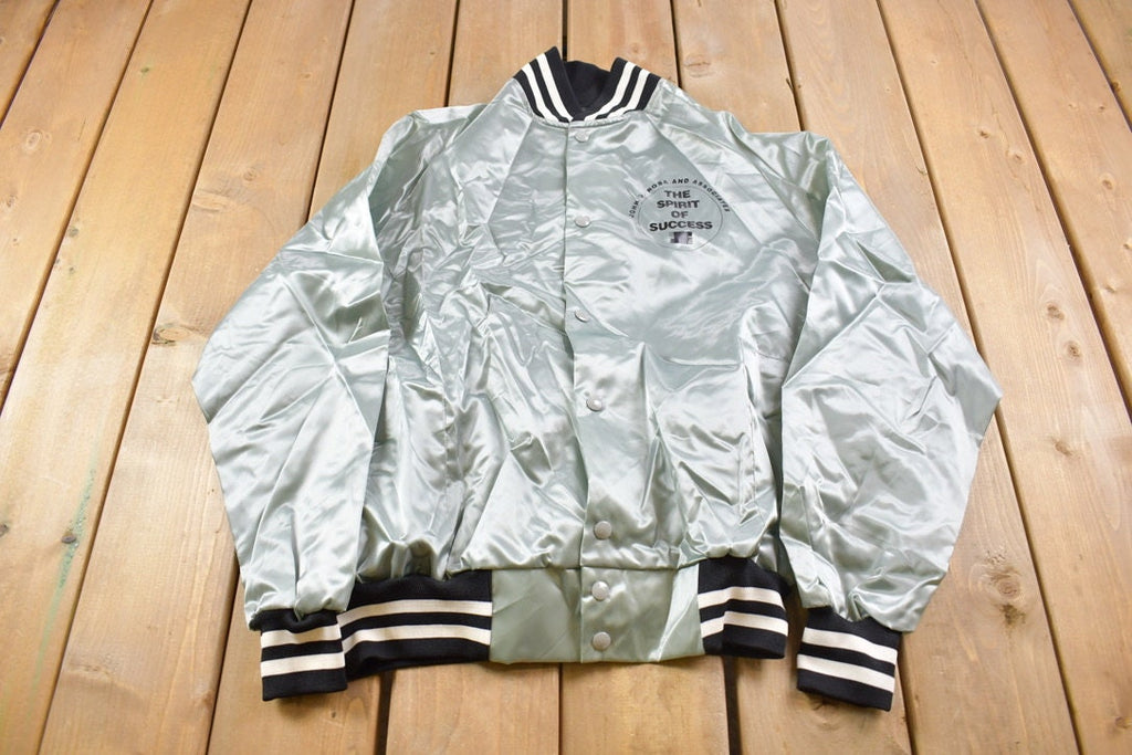 Vintage 1980s John D. Roba And Associates The Spirt Of Success Satin Bomber Snap Button Silver Jacket