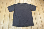 Vintage 1990s Single Stitch Only The Strong Survive Tultex T-Shirt Joke