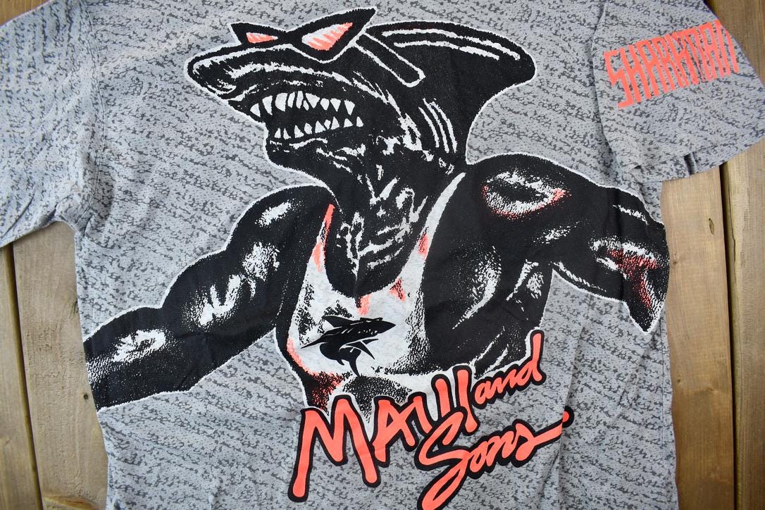 Vintage 1990s Maui And Sons Sharkman All Over Print Graphic T Shirt