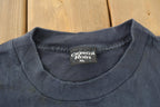 Vintage 1990s FEARLESS All Over Print Skull Graphic T-Shirt