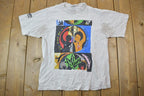 Vintage 1990s Oxfam Canada Gym Master Graphic T-Shirt