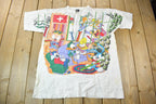 Vintage 1990s Tiny Tunes Destination Alps All Over Print Graphic T-Shirt  Warner Bros  Looney Tunes  3XL  CUT NECK