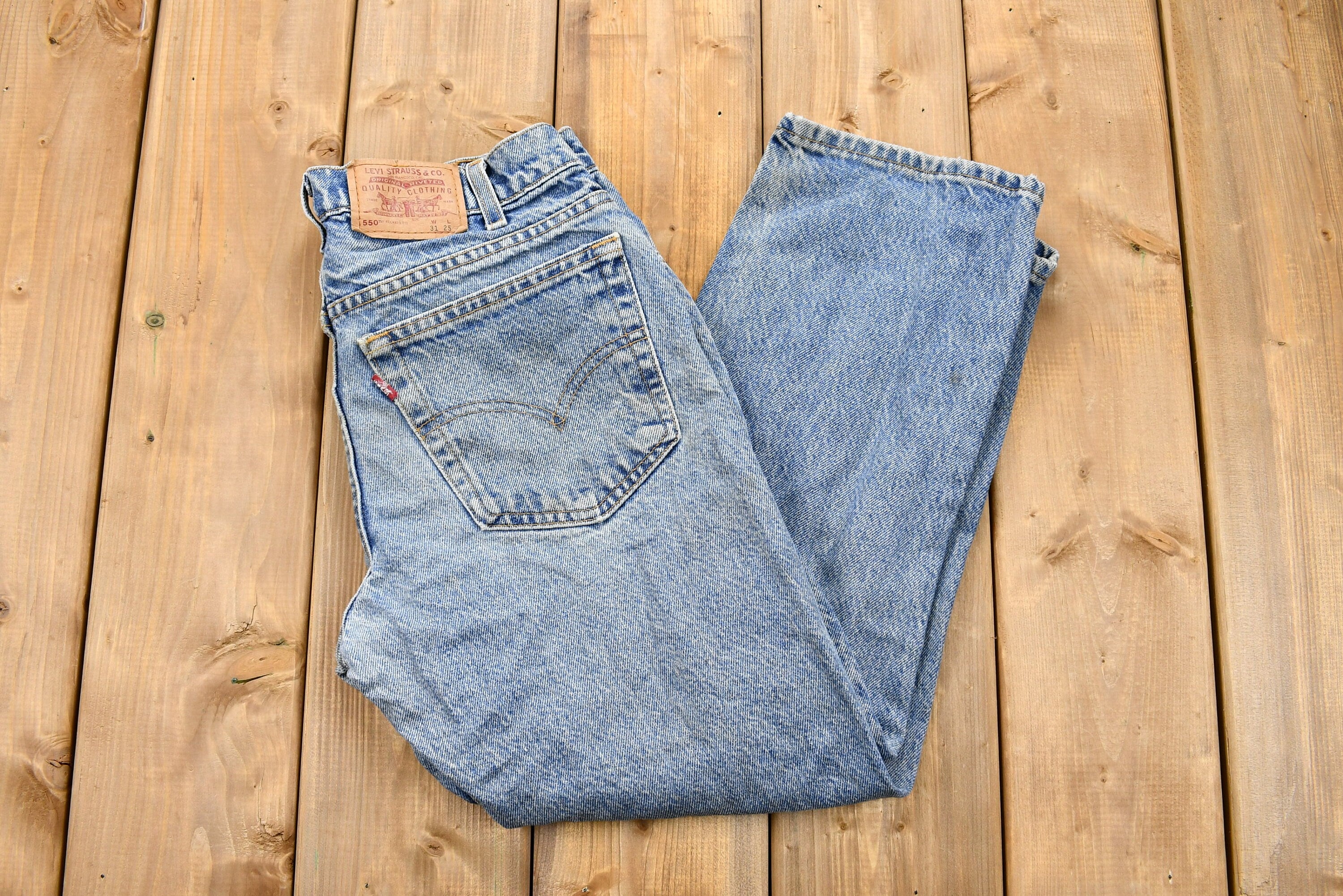 Vintage 1990s Distressed Levi's 550 Light Wash Jeans