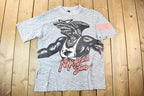 Vintage 1990s Maui And Sons Sharkman All Over Print Graphic T Shirt