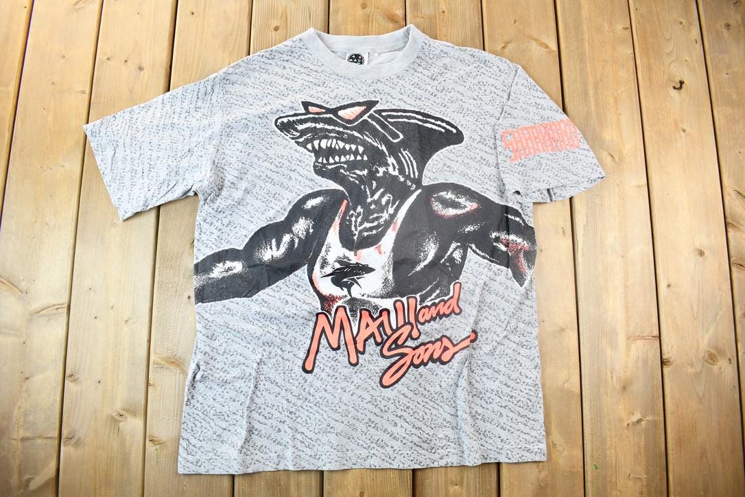 Vintage 1990s Maui And Sons Sharkman All Over Print Graphic T Shirt