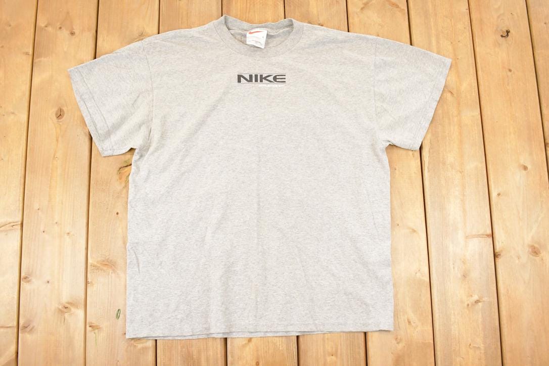 Vintage 1990s Nike Athletics Graphic Print Sportswear T-Shirt Men's L