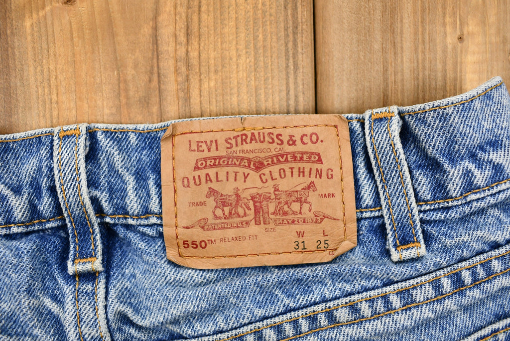Vintage 1990s Distressed Levi's 550 Light Wash Jeans