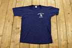 Vintage 1990s Assumption High School Graphic T-Shirt