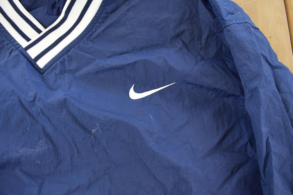 Vintage 1990s Nike Embroidered Mini Swoosh Pullover Windbreaker Men's XL