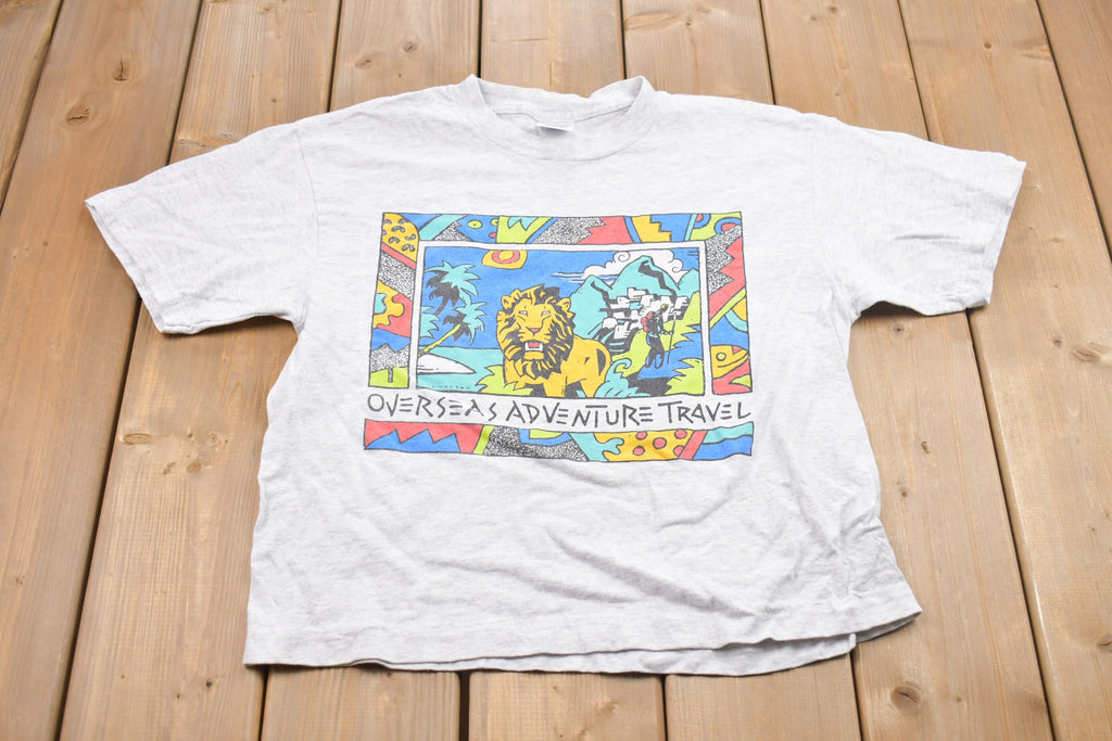 Vintage 1990s Overseas Adventure Travel Graphic T-Shirt