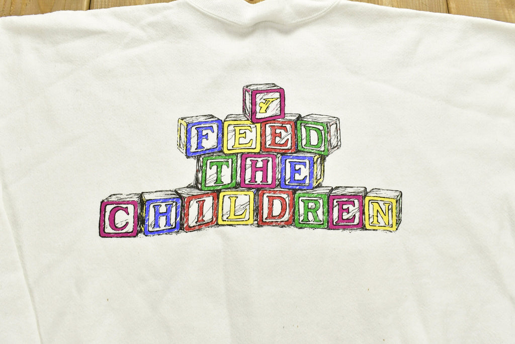 Vintage 1990s "Feed The Children" Graphic Christmas Sweater , 90s Holiday Crewneck , Winter Wear , Festive Graphic Print