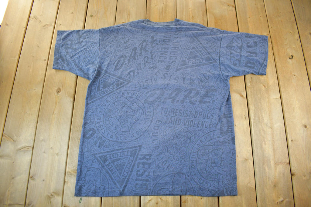 Vintage 1990s D.A.R.E All Over Print Graphic T-Shirt Men's XL
