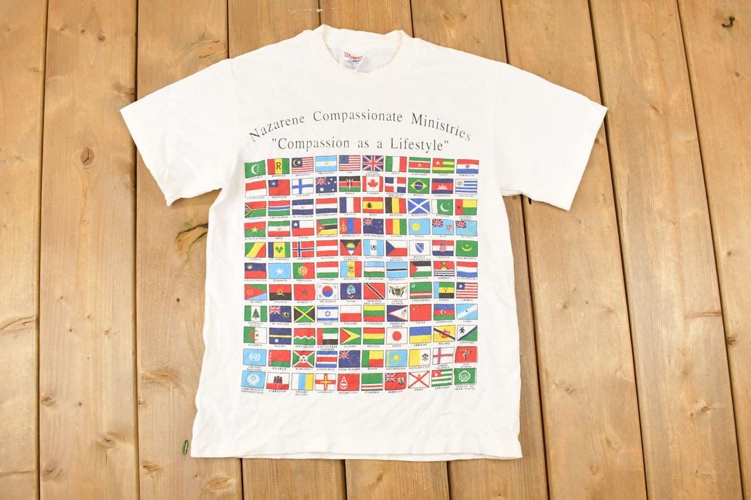 Vintage 1990s Compassion As A Lifestyle Souvenir Multi Flag FAB T-Shirt Men's S