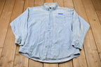 Vintage 1990s Tri-Mountain Nestle Embroidered Button Up Shirt