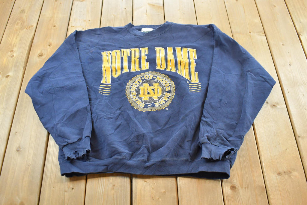 Vintage 1990s Notre Dame University Fighting Irish Thrashed Crewneck Sweatshirt Men's 2XL / NCAA College Spellout Sweater / Made in USA