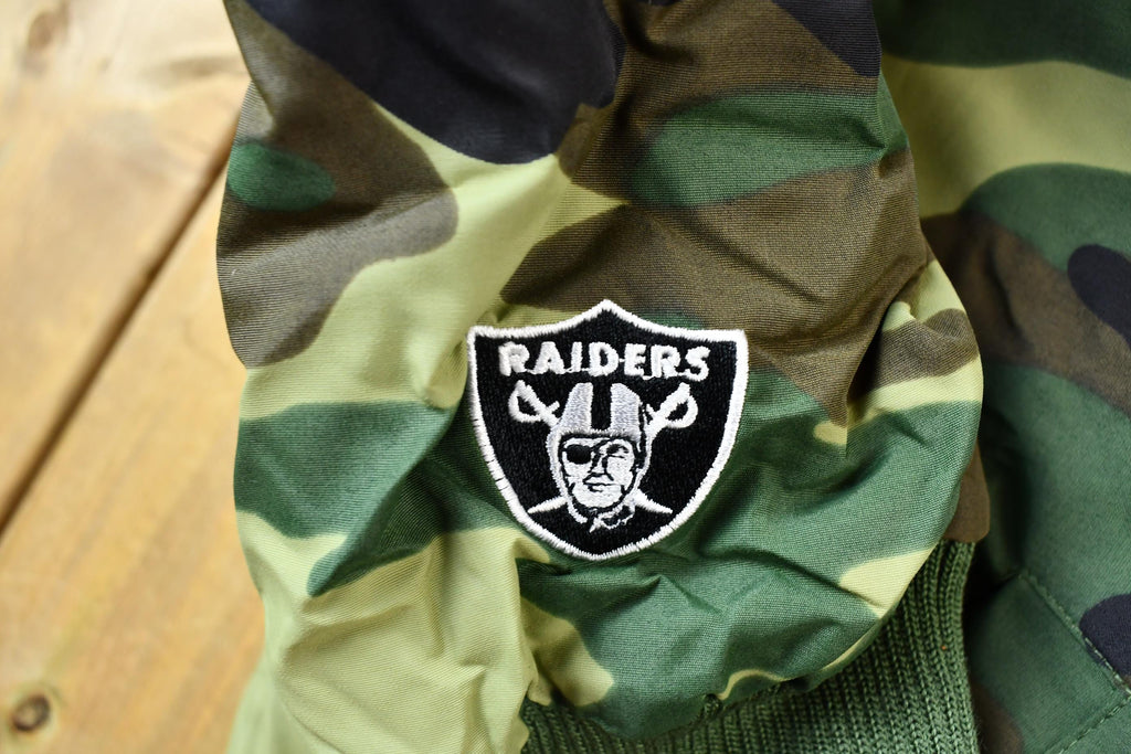 Vintage 1990s Camo Raiders NFL Football Hooded Puffer Jacket
