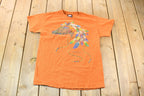 Vintage 1990s Orange Souvenir Arizona USA Feather and Bead Horse Travel T-Shirt