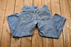 Vintage 1990s Distressed Levi's 550 Light Wash Jeans