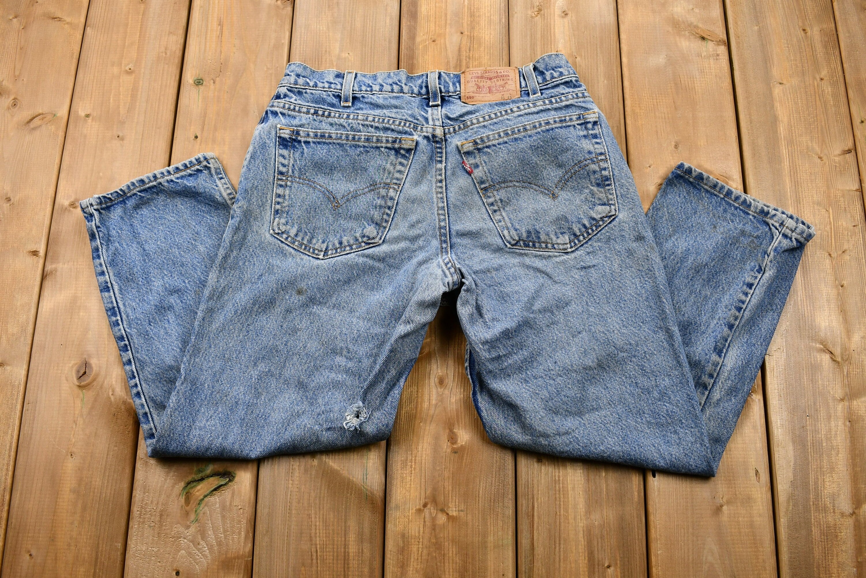 Vintage 1990s Distressed Levi's 550 Light Wash Jeans