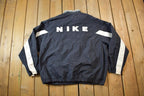Vintage 1990s Nike Red Tab Back Spellout Windbreaker Jacket - XXL