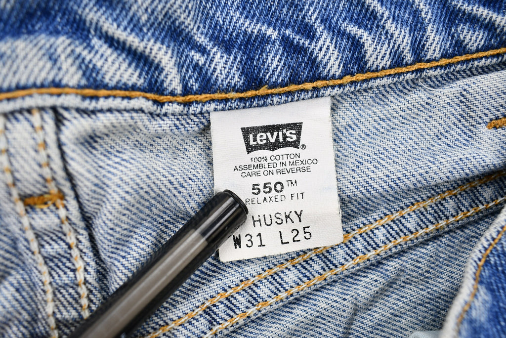 Vintage 1990s Distressed Levi's 550 Light Wash Jeans