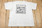 Vintage 1988 Bass Ackwards Fish Ray Troll Graphic T-Shirt
