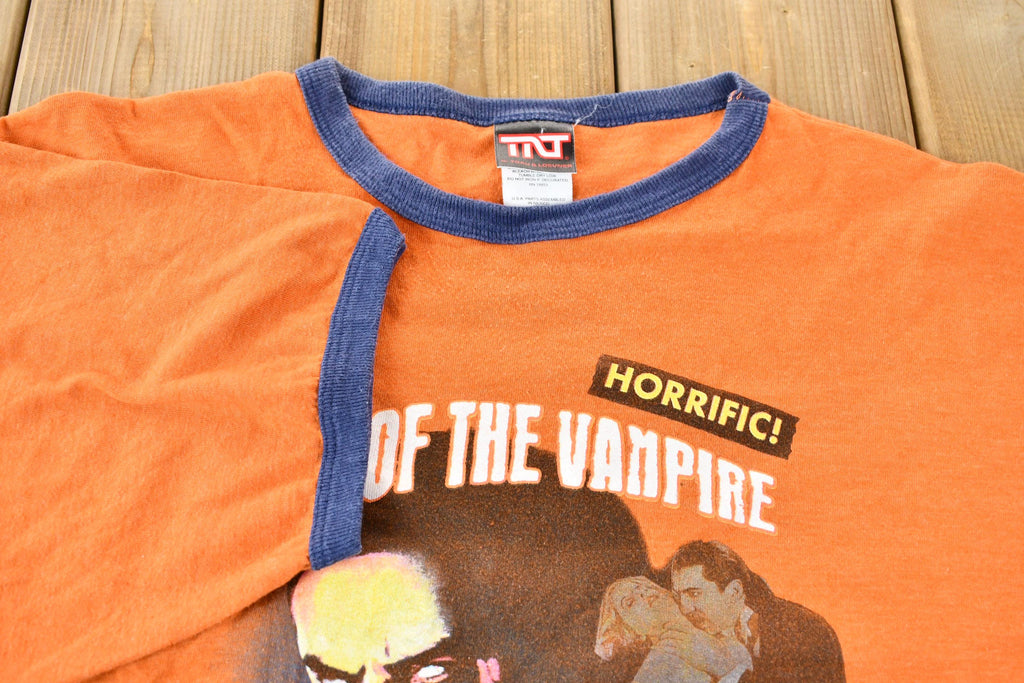 Vintage 2005 Dracula Night of the Vampire Orange and Blue Ringer Graphic T-Shirt