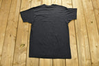 Vintage 1980s Fa Na Bona Jobba Graphic T-Shirt
