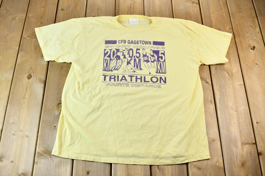 Vintage 1990s Light Yellow Penmans CFB Gagetown Short Course Triathlon Single Stitch Graphic T-Shirt